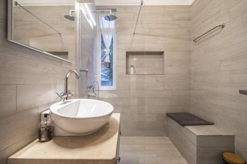 a bathroom with a bowl sink and a shower at Charming Villa, spacious, beautiful views! in Funchal