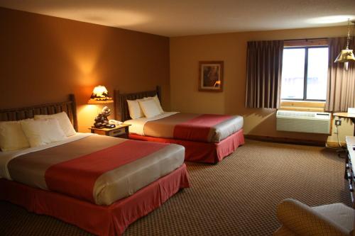 a hotel room with two beds and a window at The Lodge at Crooked Lake in Siren