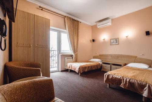 Postel nebo postele na pokoji v ubytování Ekaterina II Hotel