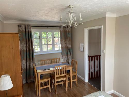 a dining room with a table and chairs and a window at Longs Hotel & Inn in Woburn