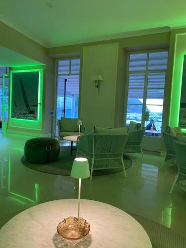 a living room with green lighting and a table at Hotel Miramare & Spa in Sestri Levante