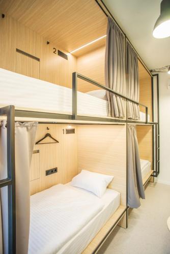 a room with three bunk beds in a room at CAPSULE HOTEL & HOSTEL in Kharkiv