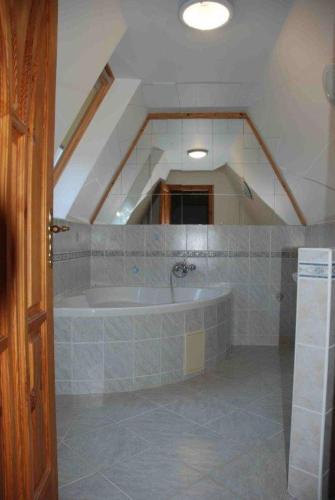 a bathroom with a bath tub in a attic at Domček pod Starým mestom in Banská Štiavnica