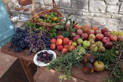 a bunch of fruits and vegetables on a wooden table at bougainvilla in Fodele