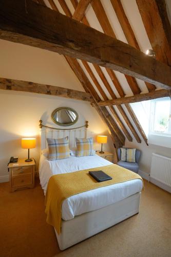 a bedroom with a large bed in a attic at Waveney House Hotel in Beccles