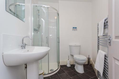 a bathroom with a sink and a shower and a toilet at Cherry Property - Mango Suite in Blackpool