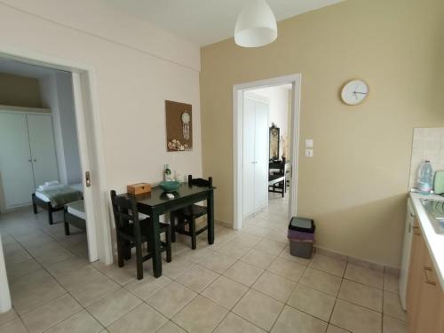 a kitchen and dining room with a table and a clock at Sirios in Acharavi