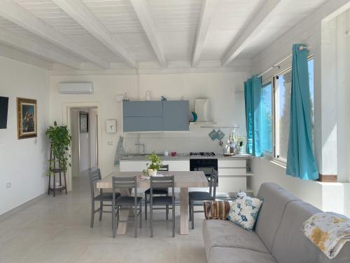 a living room with a couch and a table at Attico vista mare in villa antica in Torre Pali 