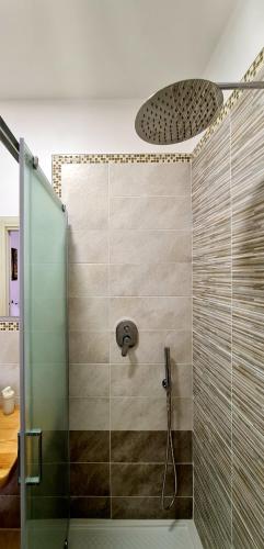 a shower with a glass door in a bathroom at Scapriccio Relax in Serrara Fontana
