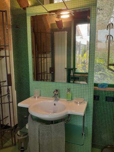 a bathroom with a sink and a mirror at La Vittoria 10 – La Soglia della Val d’Orcia in Chianciano Terme