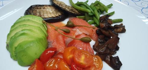 a white plate of food with vegetables and meat at Ines bed and breakfast in Giardini Naxos