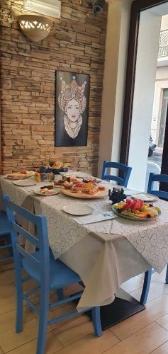 a table with plates of food on top of it at Ines bed and breakfast in Giardini Naxos