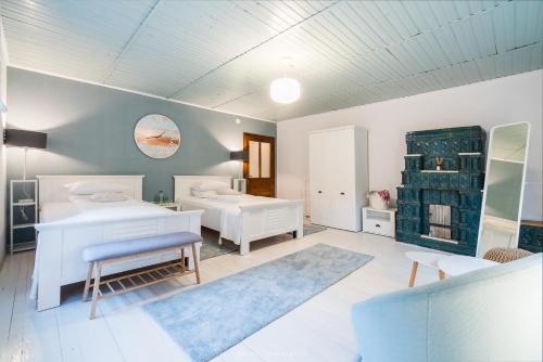 a bedroom with two beds and a table and a couch at River House in Bran