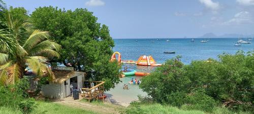 a group of people in the water at a beach at BO SOLEY, studio vue mer Les Hauts de Caritan in Sainte-Anne
