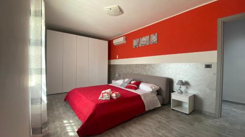 a red bedroom with a bed with a red wall at A Casa Nostra in Pietramelara