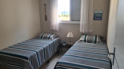 Ένα ή περισσότερα κρεβάτια σε δωμάτιο στο Apartamento Aconchego - espaço acolhedor e confortável
