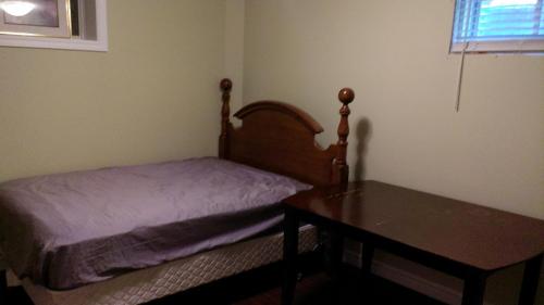 a small bedroom with a bed and a table at HB Guest Home in Waterloo