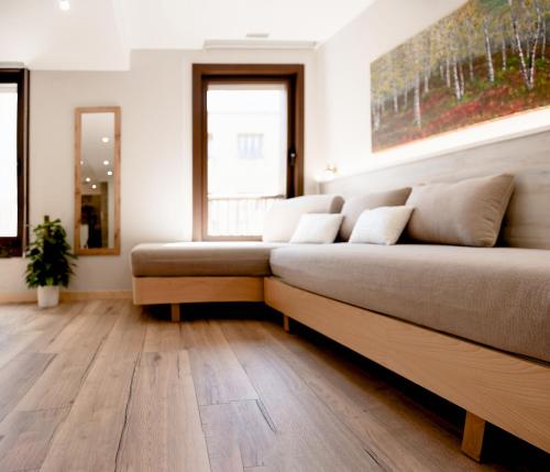 a large couch in a room with wooden floors at Casa Miño in Ourense