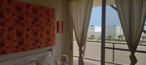 a bedroom with a bed and a large window at KatlantiK Ca Madeira Deluxe in Sal Rei