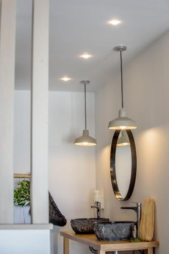 a bathroom with a sink and a mirror at Laia Seafront Luxury Apartments in Agia Pelagia
