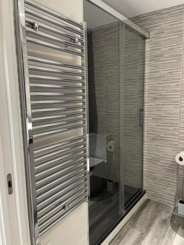 a shower with a glass door in a bathroom at Cap Salou Zeus in Salou