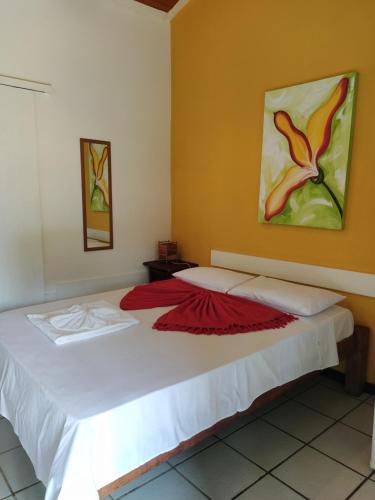 a bedroom with a bed with two towels on it at Pousada Canto De Imbassai in Imbassai
