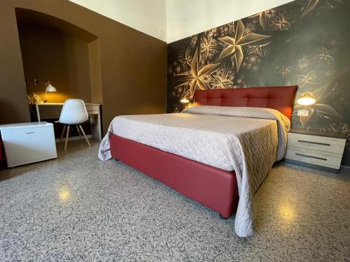 a bedroom with a red bed and a desk at CconfortHotels R&B Central Rooms in Bari