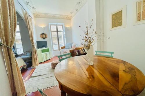 a living room with a wooden table in a room at Great studio in the heart of Cannes Meynadier old city neighbourhood ! in Cannes