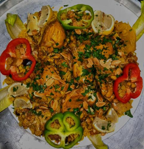 a plate of food with vegetables on a table at Basant Villa in Wadi Musa