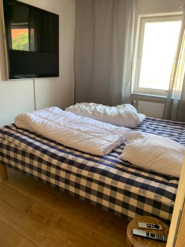 a bed with two pillows on it in a room at luksus spahus i skagen in Skagen