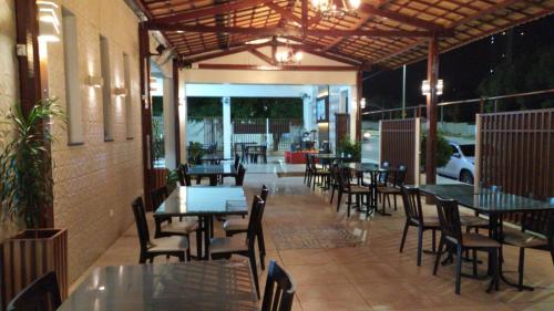 an outdoor patio with tables and chairs and tables and chairs at Pousada Lagoa Seca in Juazeiro do Norte