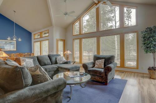 a large living room with couches and chairs andwindows at 1 Colonial in Sunriver