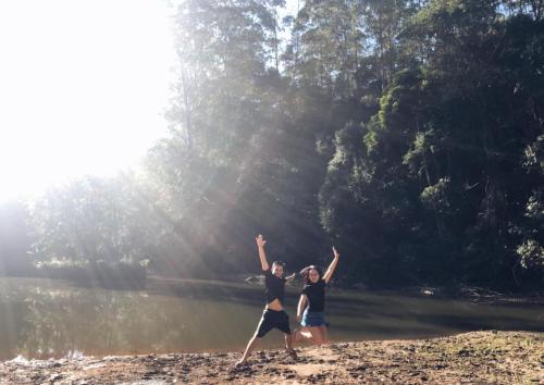 two people standing on a beach with their arms in the air at Sitio Arco Iris da Lia in São Roque