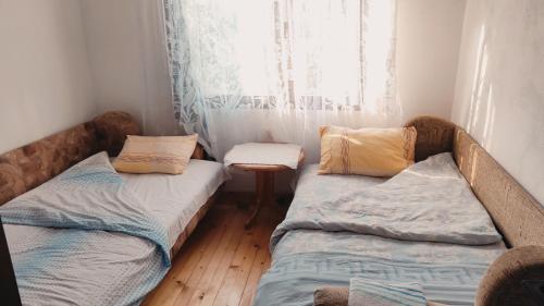 twee bedden in een kamer met een raam bij 202 in Bijelo Polje