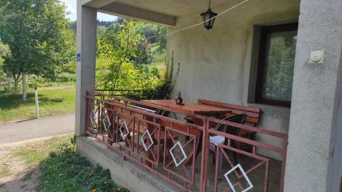 a porch with a table on the side of a house at 202 in Bijelo Polje