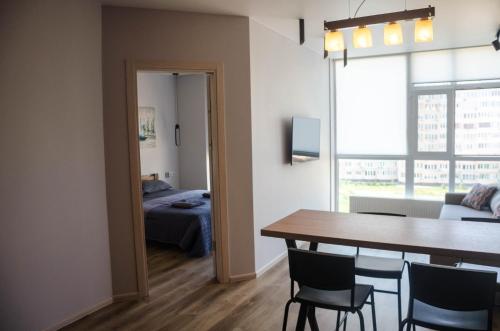 a room with a table and chairs and a bedroom at Kokos Avenue Loft Apartments in Yuzhne
