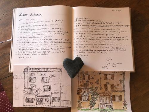 an open book with a heart on the pages at CASA ANGELA Stayerat a SEGUSINO Valdobbiadene in Segusino