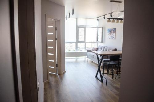 a living room with a table and a dining room at Kokos Avenue Loft Apartments in Yuzhne