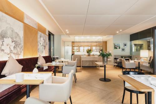 a restaurant with tables and couches and tables and chairs at Residence Hotel in Vaduz
