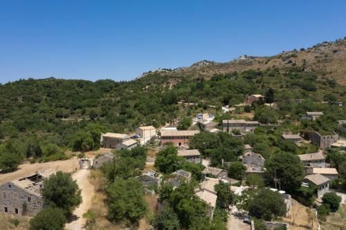 an aerial view of a village in a mountain at The Merchants House in Perítheia