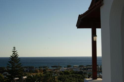 a view of the ocean from a house at Lofos Hotel in Plakias
