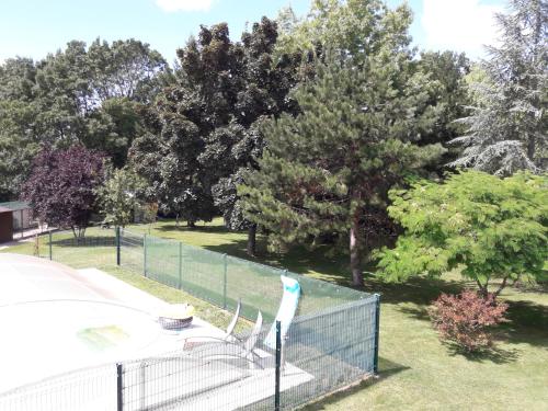 a bird on a fence in a park at Logis de LANGE studio 2 p in Saint-Hilaire-la-Palud