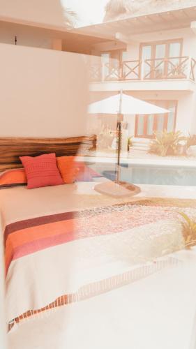 a bedroom with a bed and a swimming pool at Casa Kuaa in Brisas de Zicatela