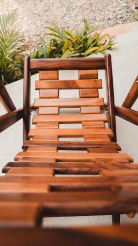 a wooden bench sitting next to a table with plants at Casa Kuaa in Brisas de Zicatela