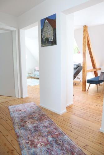 a living room with a rug on a wooden floor at Ferienwohnung Habitat in Gaggenau