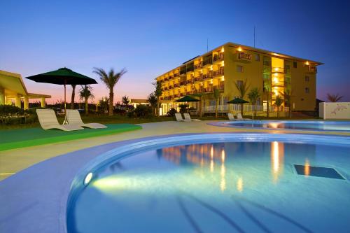 a swimming pool in front of a hotel at AJ Resort Island Ikeijima in Uruma