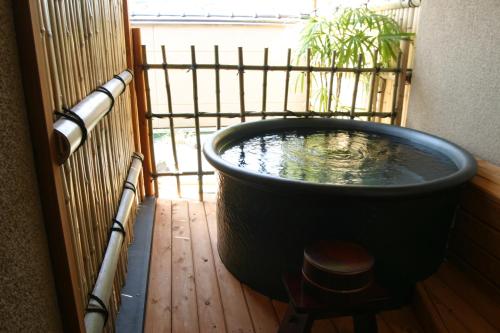 a large bath tub with a plant in it at Ryokan Shinsen in Takachiho
