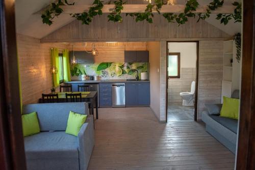 a living room and kitchen in a tiny house at Stacja Wygoda in Lubiszewo