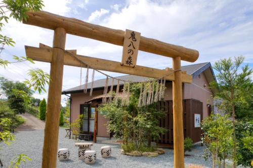 a wooden sign in front of a building at Ryokan Shinsen in Takachiho
