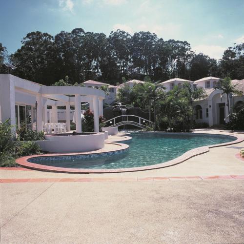 a swimming pool in front of a house at Royal Woods Resort in Gold Coast